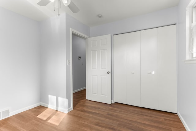 15945 Horger Ave, Allen Park, MI 48101 - unfurnished bedroom with wood finished floors, baseboards, a closet, and a ceiling fan