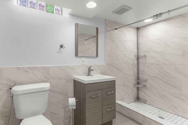 15945 Horger Ave, Allen Park, MI 48101 - full bathroom featuring tile walls, a tile shower, toilet, vanity, and wainscoting