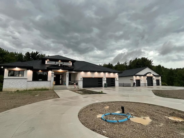 815 N Milford Rd, Milford, MI 48381 - view of front of house featuring a garage, curved driveway, and stone siding