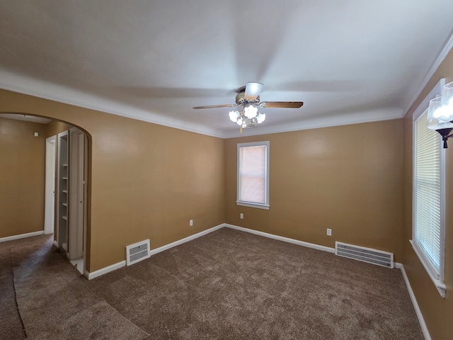 19415 Riopelle St, Highland Park, MI 48203 - carpeted empty room featuring arched walkways, ceiling fan, healthy amount of natural light, baseboards, and crown molding