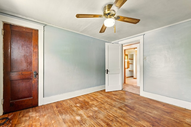 1410 12th St, Port Huron, MI 48060 - unfurnished bedroom with hardwood / wood-style flooring, baseboards, and a ceiling fan