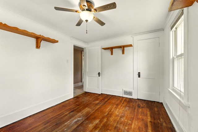 1410 12th St, Port Huron, MI 48060 - unfurnished bedroom with dark wood-style flooring, a ceiling fan, and baseboards