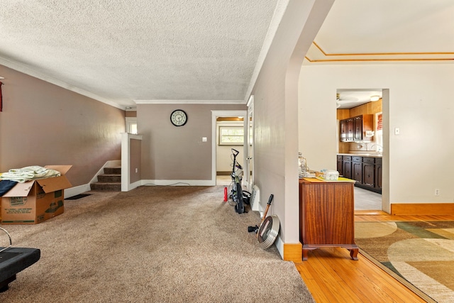 1410 12th St, Port Huron, MI 48060 - interior space with crown molding, baseboards, stairs, a textured ceiling, and arched walkways