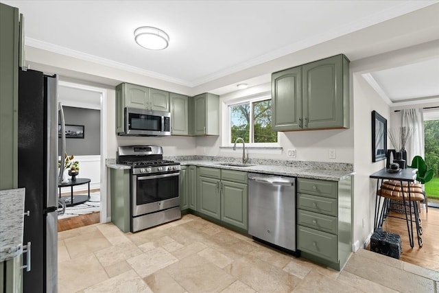 6557 N Twindale, Shelby Twp, MI 48316 - kitchen featuring green cabinetry, appliances with stainless steel finishes, a sink, crown molding, and light stone counters