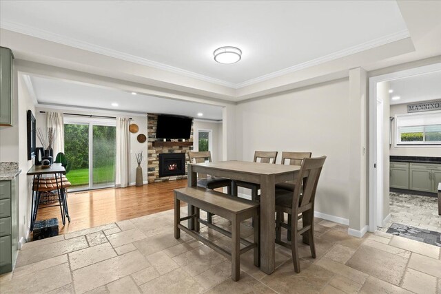 6557 N Twindale, Shelby Twp, MI 48316 - dining space with stone tile floors, a fireplace, recessed lighting, crown molding, and baseboards