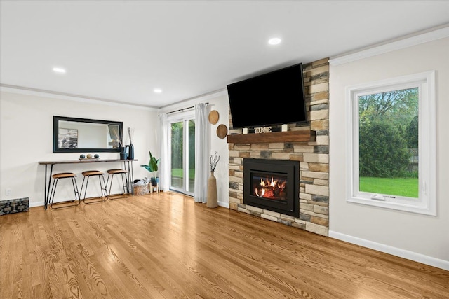 6557 N Twindale, Shelby Twp, MI 48316 - unfurnished living room with crown molding, a stone fireplace, wood finished floors, baseboards, and recessed lighting
