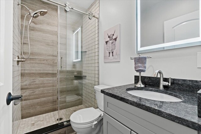 6557 N Twindale, Shelby Twp, MI 48316 - bathroom with a shower stall, toilet, and vanity