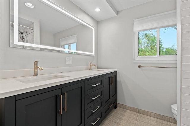 6557 N Twindale, Shelby Twp, MI 48316 - bathroom with toilet, double vanity, a shower, baseboards, and recessed lighting