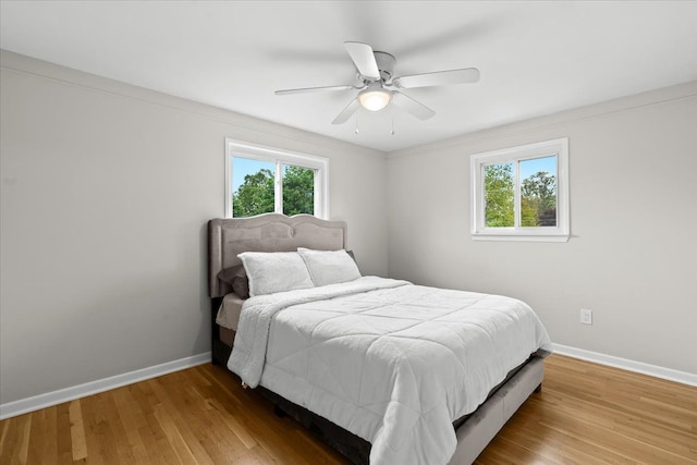 6557 N Twindale, Shelby Twp, MI 48316 - bedroom with multiple windows, baseboards, and wood finished floors