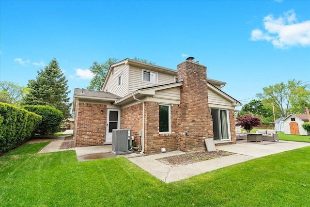 6557 N Twindale, Shelby Twp, MI 48316 - rear view of house with an outdoor hangout area, central AC, a patio area, a chimney, and a yard