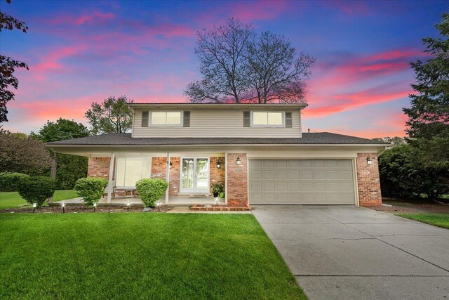 6557 N Twindale, Shelby Twp, MI 48316 - traditional-style home featuring driveway, a front yard, brick siding, and an attached garage