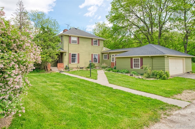 835 W Marr Rd, Howell, MI 48855 - view of front of house with asphalt driveway, a front yard, a garage, and a chimney