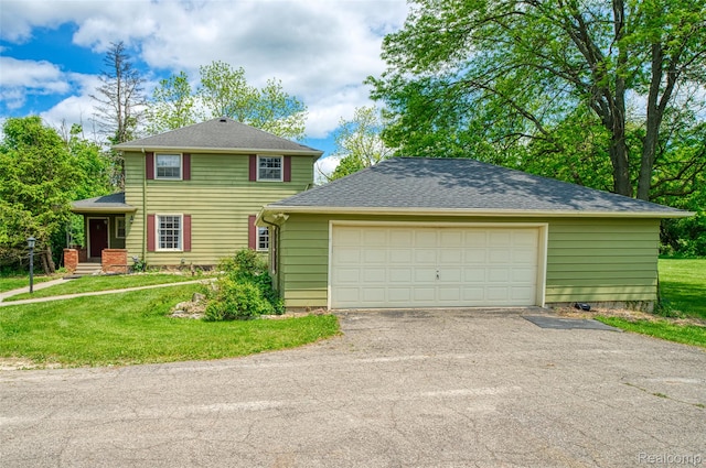 835 W Marr Rd, Howell, MI 48855 - view of front facade featuring a garage, a front lawn, a shingled roof, and asphalt driveway