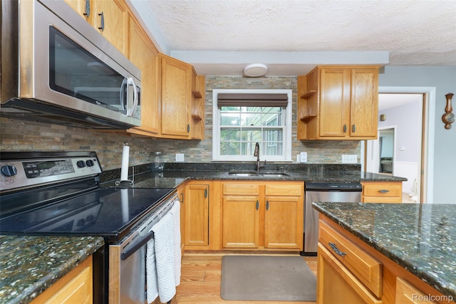 835 W Marr Rd, Howell, MI 48855 - kitchen featuring stainless steel appliances, a sink, light wood-type flooring, open shelves, and decorative backsplash