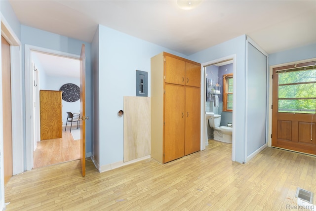 835 W Marr Rd, Howell, MI 48855 - unfurnished bedroom with light wood finished floors, ensuite bathroom, and electric panel