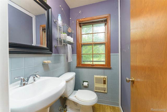 835 W Marr Rd, Howell, MI 48855 - half bath featuring heating unit, a sink, tile walls, toilet, and wood finished floors