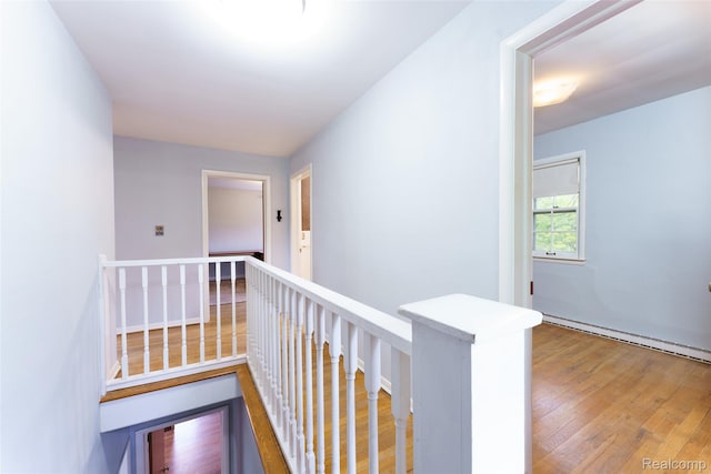 835 W Marr Rd, Howell, MI 48855 - hall featuring an upstairs landing, wood finished floors, and baseboard heating