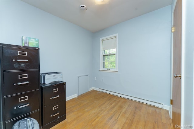 835 W Marr Rd, Howell, MI 48855 - unfurnished office with a baseboard radiator, light wood-style flooring, and baseboards