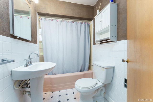 835 W Marr Rd, Howell, MI 48855 - bathroom featuring tile walls, toilet, shower / bath combination with curtain, and wainscoting