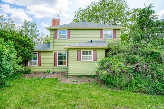 835 W Marr Rd, Howell, MI 48855 - rear view of house with a chimney and a lawn