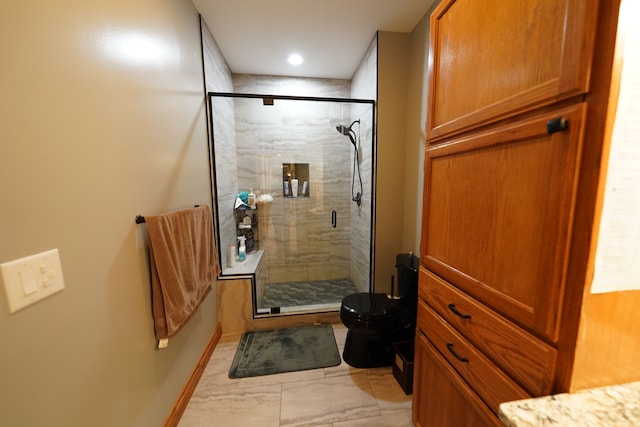 12161 Ladd Rd, Brooklyn, MI 49230 - full bathroom featuring marble look tile flooring, a stall shower, toilet, and baseboards