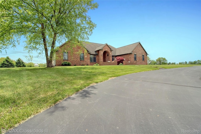 12161 Ladd Rd, Brooklyn, MI 49230 - view of front facade with brick siding and a front lawn