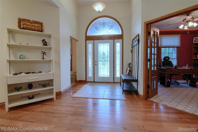 12161 Ladd Rd, Brooklyn, MI 49230 - foyer entrance featuring light wood-type flooring, a towering ceiling, and ceiling fan