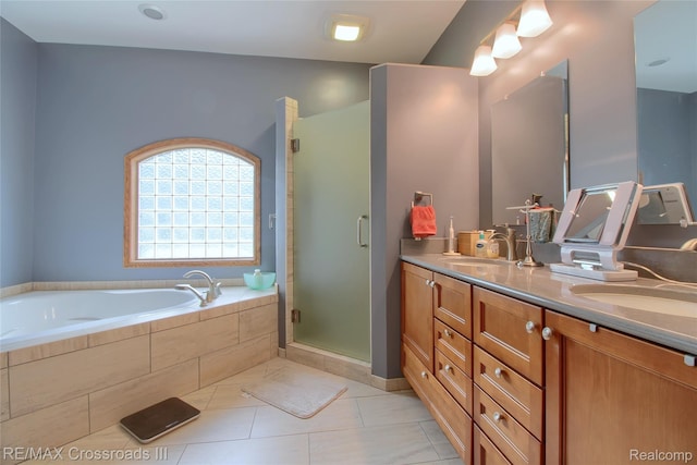12161 Ladd Rd, Brooklyn, MI 49230 - full bathroom with double vanity, a bath, a stall shower, and tile patterned flooring