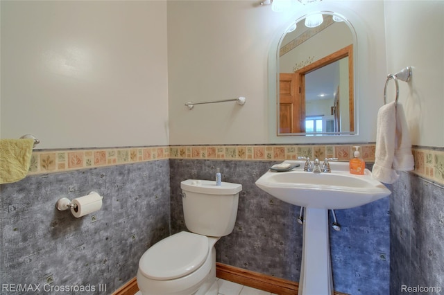 12161 Ladd Rd, Brooklyn, MI 49230 - half bath featuring toilet, a wainscoted wall, and tile walls