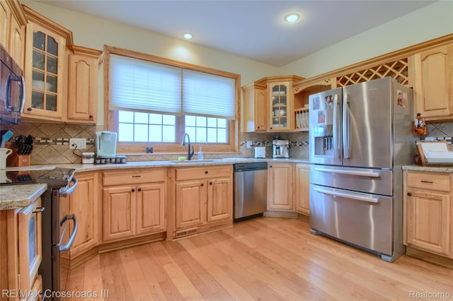 12161 Ladd Rd, Brooklyn, MI 49230 - kitchen featuring stainless steel appliances, a sink, light brown cabinetry, backsplash, and recessed lighting