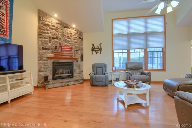 12161 Ladd Rd, Brooklyn, MI 49230 - living area with wood finished floors, ceiling fan, a stone fireplace, and baseboards