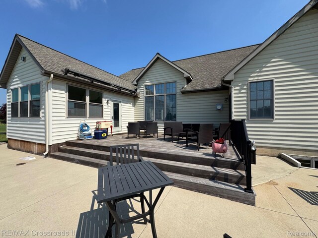 12161 Ladd Rd, Brooklyn, MI 49230 - back of property with roof with shingles, an outdoor hangout area, a wooden deck, and a patio area