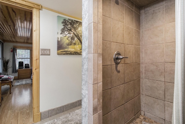 520 N Campbell Rd, Fountain, MI 49410 - bathroom featuring a tile shower and wood finished floors