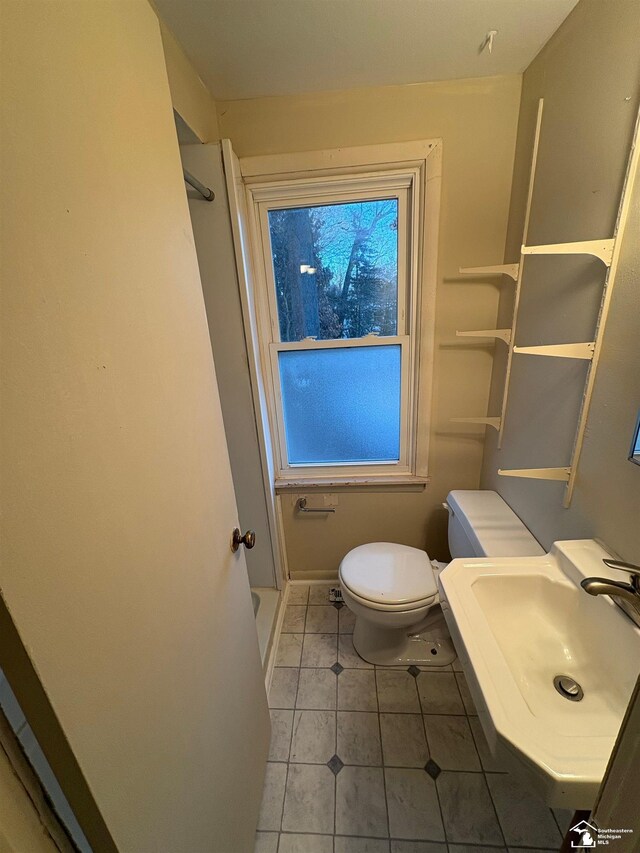 10929 S Telegraph Rd, Erie, MI 48133 - bathroom with toilet, tile patterned floors, a sink, a shower, and baseboards