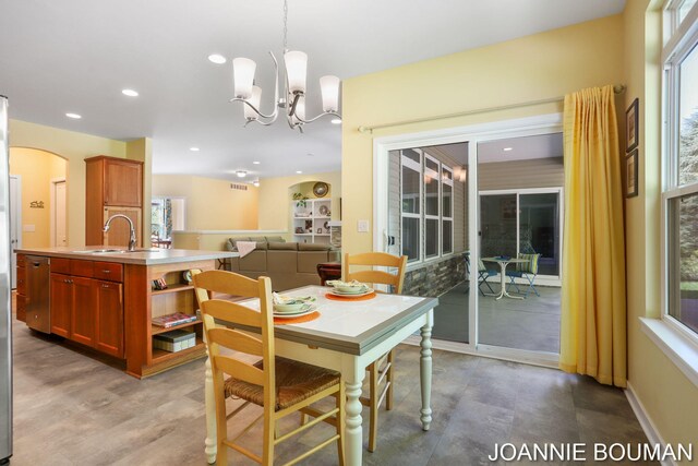 94 Cheyenne Ave, Holland, MI 49424 - dining room with a chandelier, arched walkways, and recessed lighting