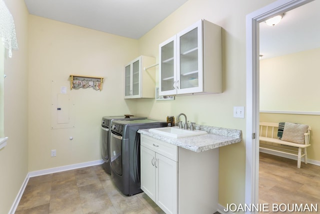 94 Cheyenne Ave, Holland, MI 49424 - washroom with independent washer and dryer, cabinet space, baseboards, and electric panel