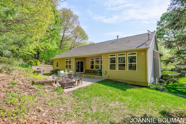 94 Cheyenne Ave, Holland, MI 49424 - rear view of property featuring a fire pit, a patio, a lawn, and a shingled roof