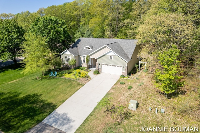 94 Cheyenne Ave, Holland, MI 49424 - view of front facade with driveway, a front lawn, a forest view, stone siding, and a shingled roof