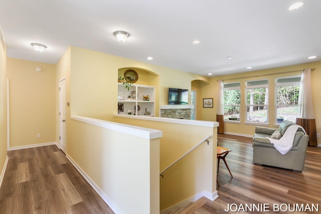 94 Cheyenne Ave, Holland, MI 49424 - hallway featuring an upstairs landing, wood finished floors, baseboards, recessed lighting, and arched walkways