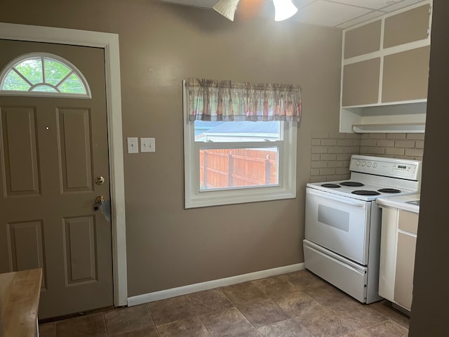 1433 Minnie St, Port Huron, MI 48060 - kitchen featuring white range with electric stovetop, decorative backsplash, baseboards, and light countertops