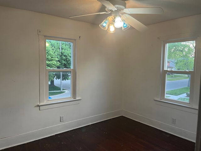 1433 Minnie St, Port Huron, MI 48060 - spare room featuring dark wood-style floors, baseboards, plenty of natural light, and ceiling fan