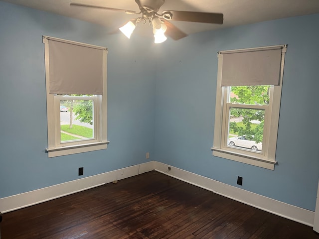1433 Minnie St, Port Huron, MI 48060 - empty room featuring plenty of natural light, dark wood-style floors, ceiling fan, and baseboards