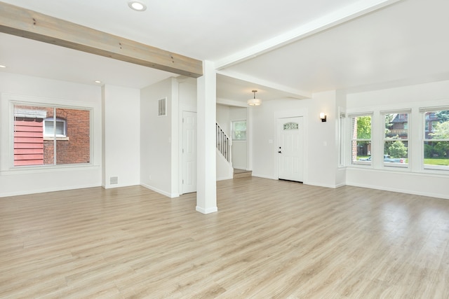 2514 Lothrop St, Detroit, MI 48206 - unfurnished living room featuring stairs, beamed ceiling, light wood-style flooring, baseboards, and recessed lighting