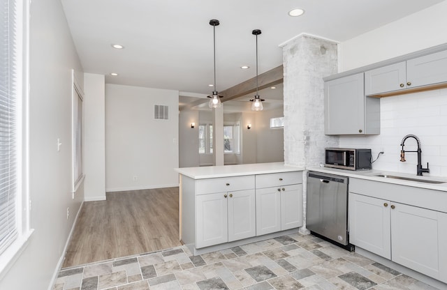 2514 Lothrop St, Detroit, MI 48206 - kitchen featuring stainless steel appliances, a sink, a peninsula, light countertops, and recessed lighting