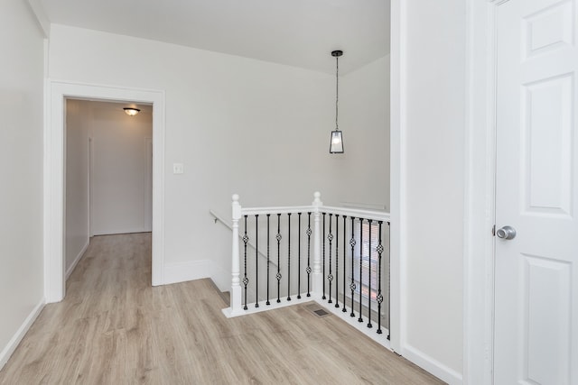2514 Lothrop St, Detroit, MI 48206 - hall with an upstairs landing, light wood-type flooring, and baseboards