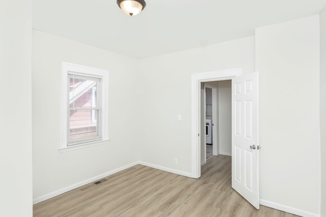 2514 Lothrop St, Detroit, MI 48206 - unfurnished room with light wood-type flooring, baseboards, and washer / clothes dryer