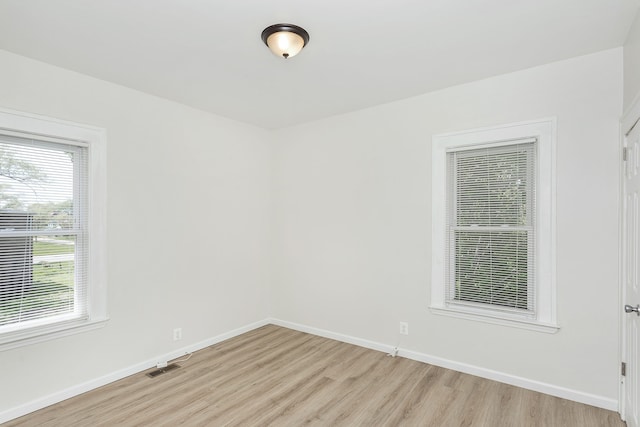 2514 Lothrop St, Detroit, MI 48206 - unfurnished room with light wood-style floors, healthy amount of natural light, and baseboards