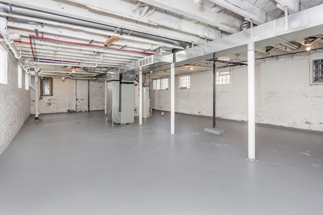 2514 Lothrop St, Detroit, MI 48206 - basement with water heater, brick wall, healthy amount of natural light, heating unit, and electric panel