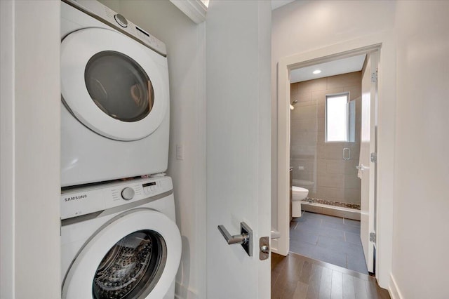 2840 John R St, Detroit, MI 48201 - laundry room featuring stacked washer / dryer, wood finished floors, and baseboards