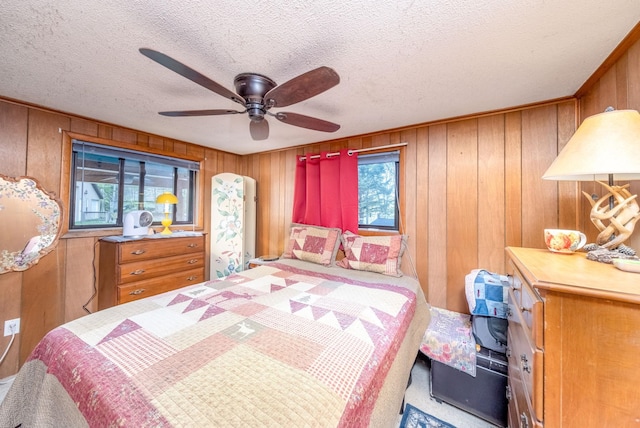 16545 Lonesome Trl, Leroy, MI 49655 - bedroom featuring wooden walls, a textured ceiling, and a ceiling fan